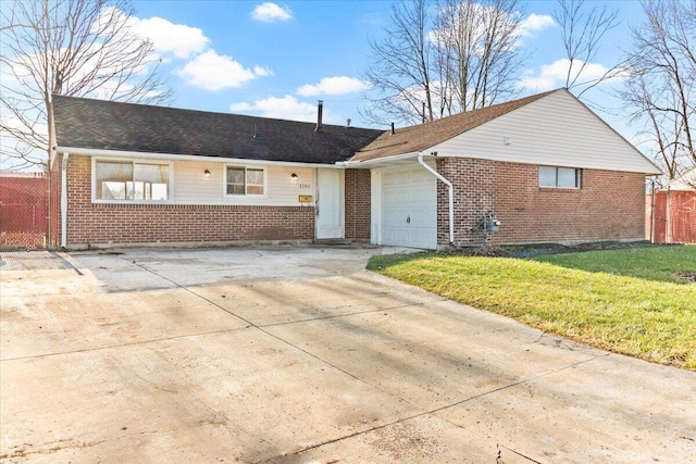 single story home with a front yard and a garage