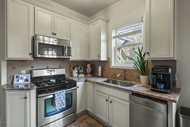 kitchen featuring white cabinets, sink, tile patterned flooring, dark stone countertops, and stainless steel appliances