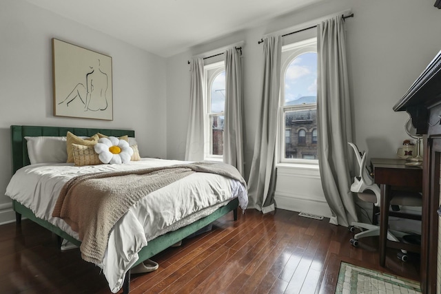 bedroom with dark hardwood / wood-style floors