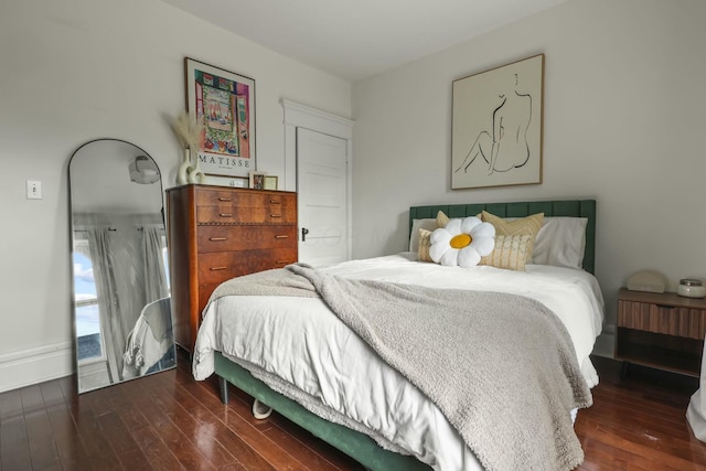 bedroom with dark hardwood / wood-style floors