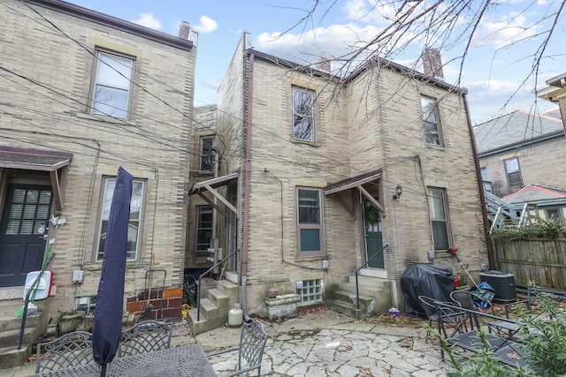 rear view of house with central AC