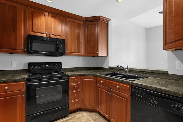 kitchen featuring sink, black appliances, and light tile patterned flooring