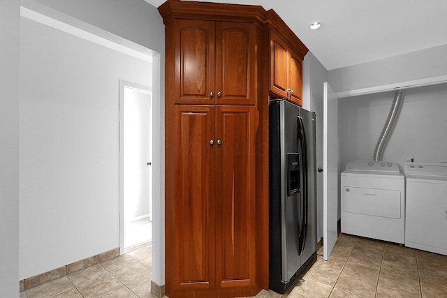 laundry room with separate washer and dryer and light tile patterned flooring