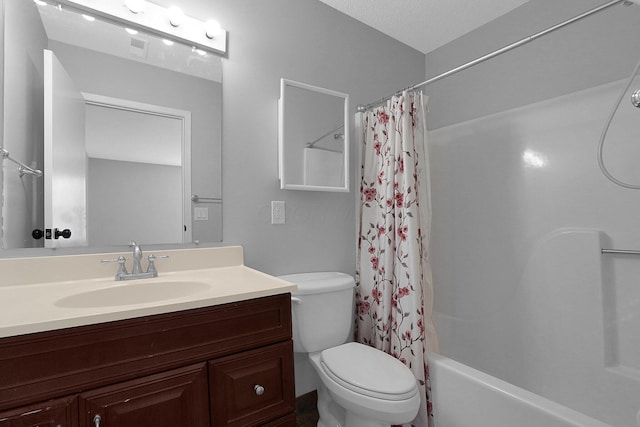 full bathroom featuring toilet, a textured ceiling, shower / tub combo, and vanity