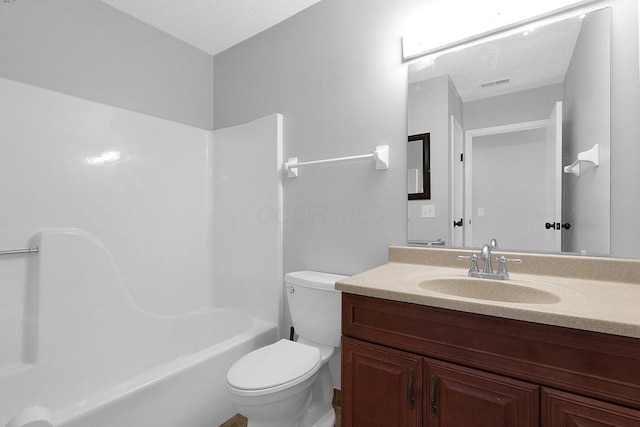 full bathroom with toilet, a textured ceiling, vanity, and shower / bathing tub combination