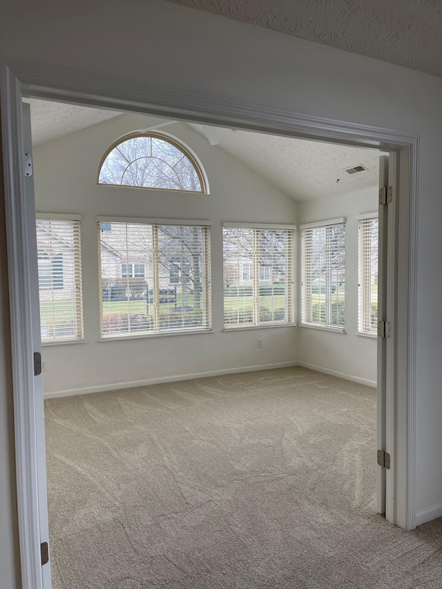 unfurnished sunroom featuring lofted ceiling