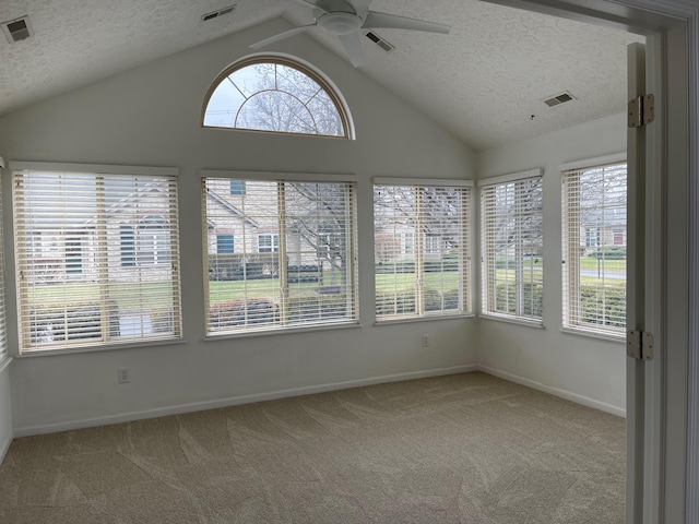 unfurnished sunroom with vaulted ceiling and ceiling fan