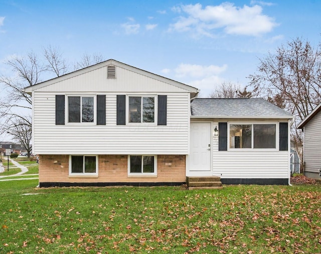 tri-level home with a front yard