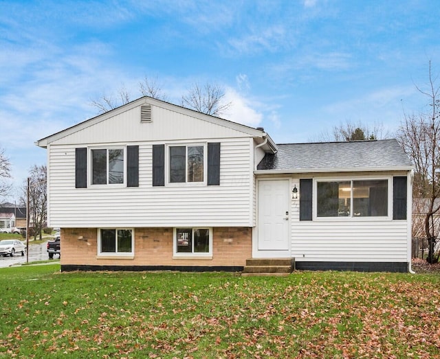 tri-level home with a front yard