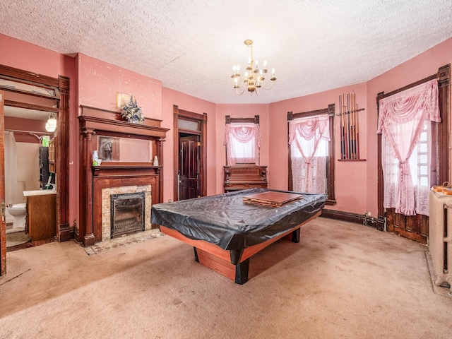 game room with a textured ceiling, light carpet, pool table, and a chandelier