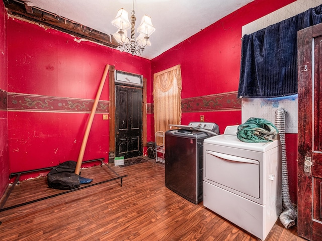 laundry room with hardwood / wood-style flooring, separate washer and dryer, and a chandelier