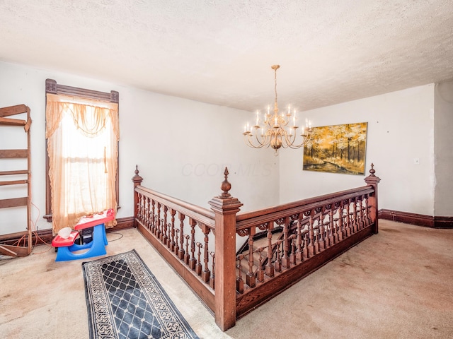 bedroom featuring carpet, a textured ceiling, and an inviting chandelier