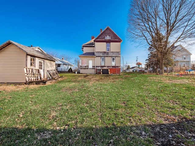 rear view of property featuring a yard