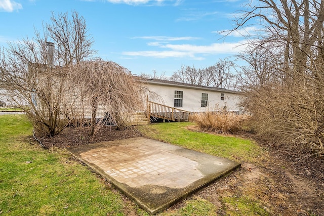 back of property featuring a yard and a patio