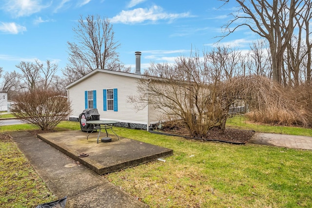 rear view of property with a patio area and a yard