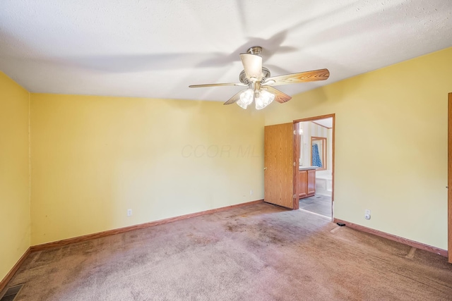 carpeted spare room with ceiling fan