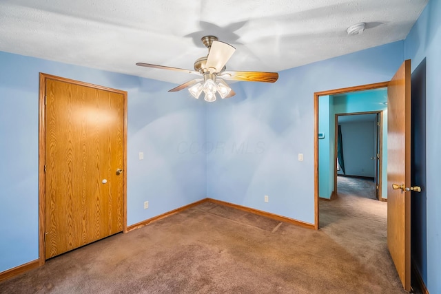 unfurnished room with ceiling fan, carpet floors, and a textured ceiling