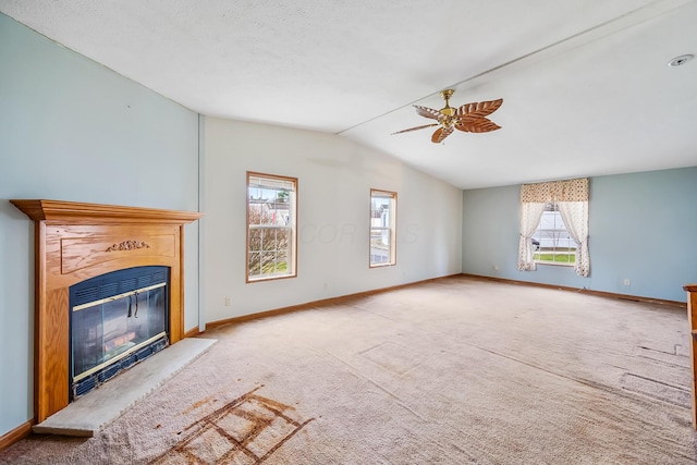 unfurnished living room with ceiling fan, lofted ceiling, and light carpet