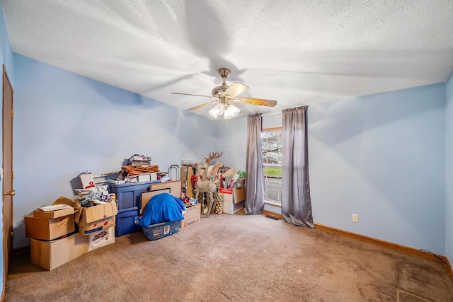 interior space with carpet, a textured ceiling, and ceiling fan