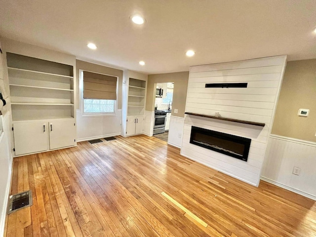 unfurnished living room with light wood-type flooring