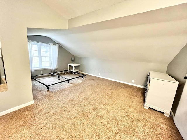 bonus room featuring carpet floors and vaulted ceiling