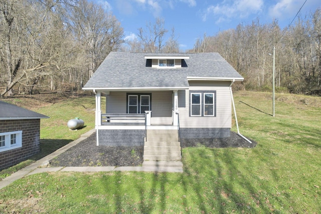 bungalow with covered porch and a front yard