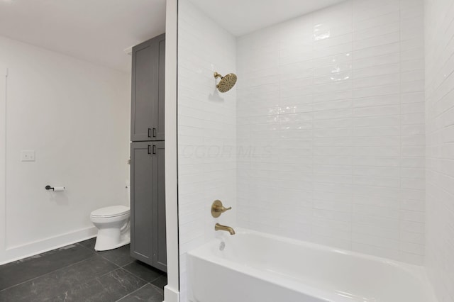 bathroom featuring tile patterned floors, toilet, and bathtub / shower combination