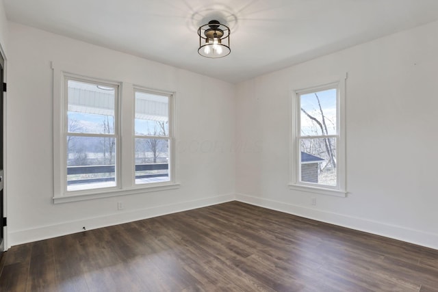 unfurnished room with dark wood-type flooring