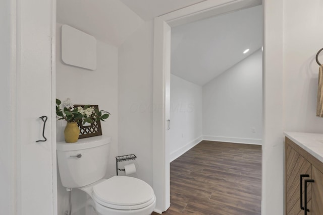 bathroom featuring wood-type flooring, vanity, and toilet