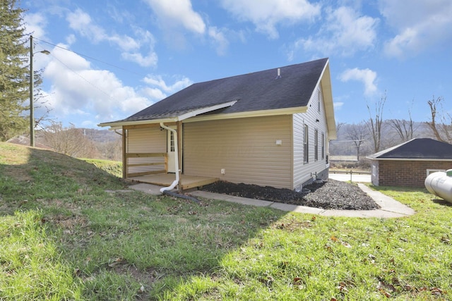 back of property featuring a yard