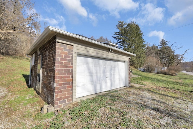 garage featuring a lawn