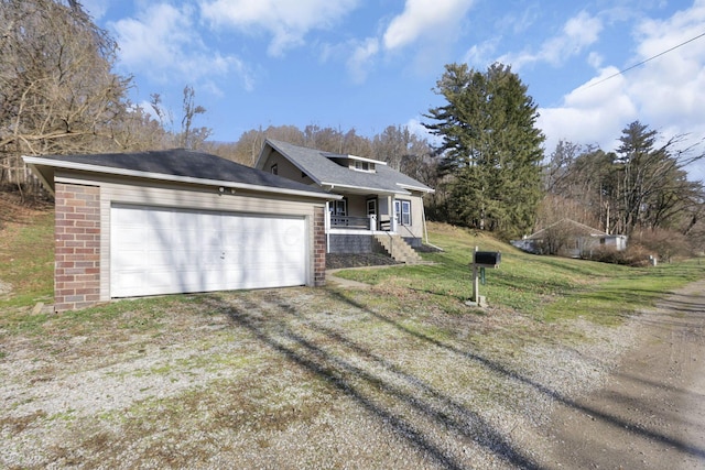 view of front facade featuring a front lawn, covered porch, and a garage