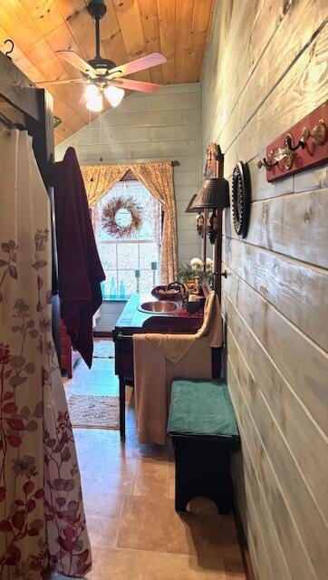 playroom featuring wood walls, sink, ceiling fan, and wooden ceiling