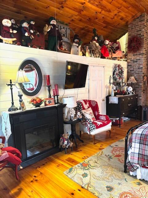 living room with hardwood / wood-style floors, wood ceiling, and vaulted ceiling