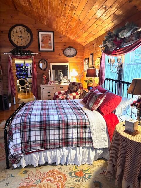 bedroom featuring wood walls, wood ceiling, and vaulted ceiling