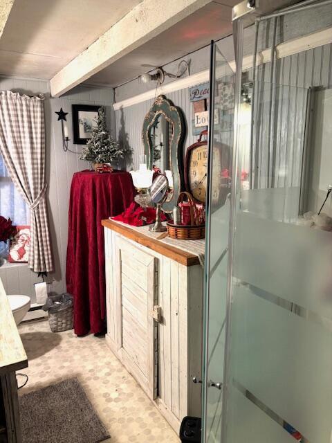 bathroom with a shower with door and vanity