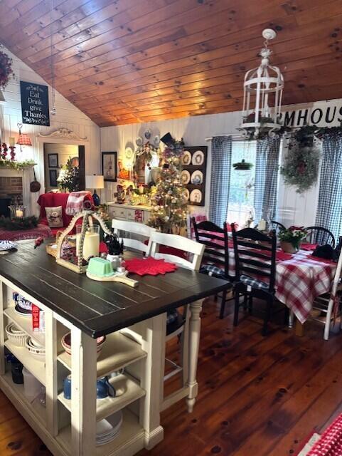 dining space featuring dark hardwood / wood-style floors, lofted ceiling, and a notable chandelier