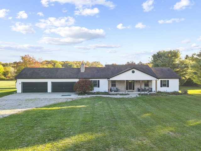 ranch-style house with a front yard, a garage, and covered porch