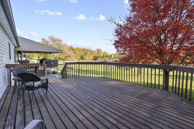 wooden terrace featuring a yard