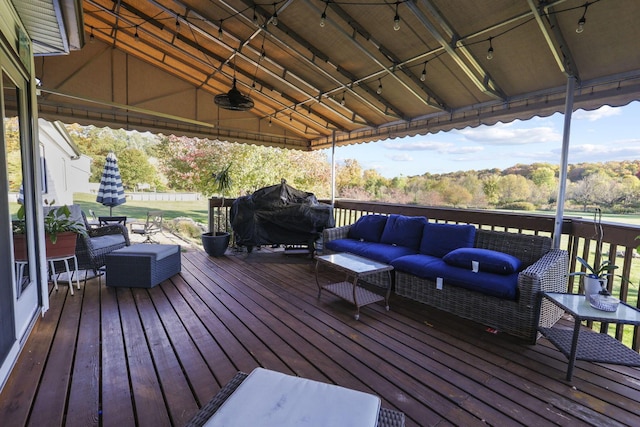 wooden terrace with grilling area and an outdoor hangout area