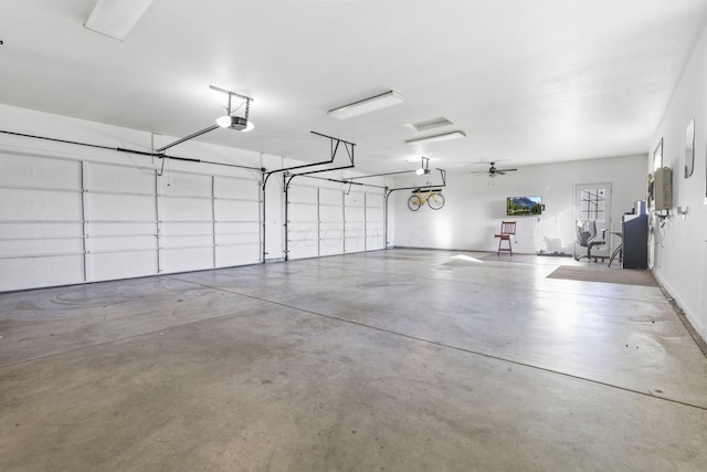 garage with a garage door opener and ceiling fan