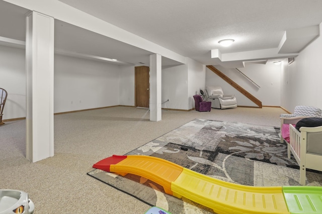 basement featuring carpet floors and a textured ceiling