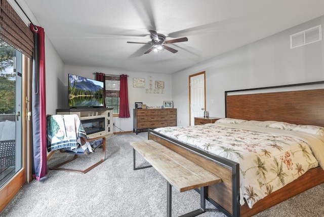 bedroom with multiple windows, access to exterior, light colored carpet, and ceiling fan