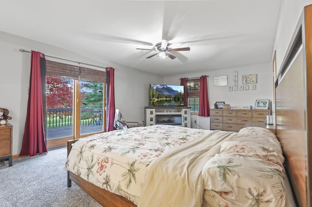 carpeted bedroom featuring access to exterior and ceiling fan