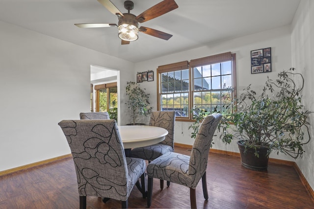 dining space featuring dark hardwood / wood-style flooring and ceiling fan