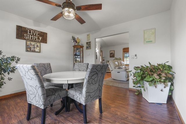 dining space featuring dark hardwood / wood-style floors and ceiling fan