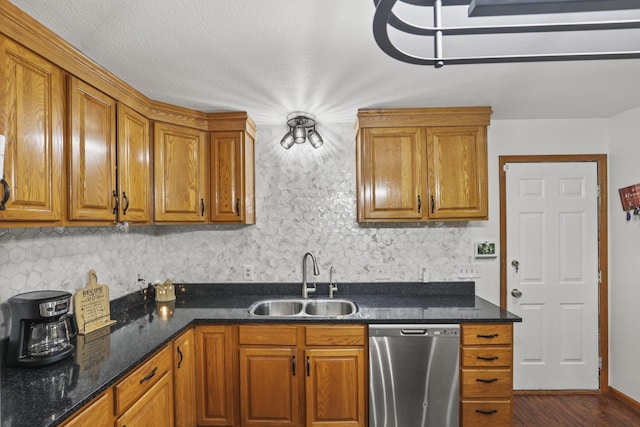 kitchen with tasteful backsplash, sink, dark stone counters, and stainless steel dishwasher