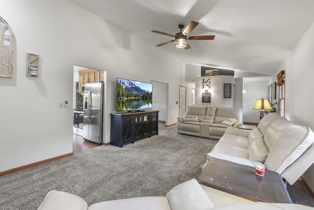 carpeted living room with vaulted ceiling and ceiling fan