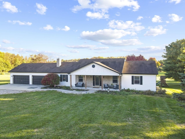 ranch-style home with a front yard, a porch, and a garage