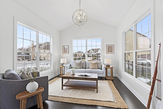 living room with vaulted ceiling, dark wood-type flooring, and a notable chandelier